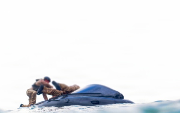 2nd Bn., 5th Marines, paddle through surf during infantry company small boat raid course