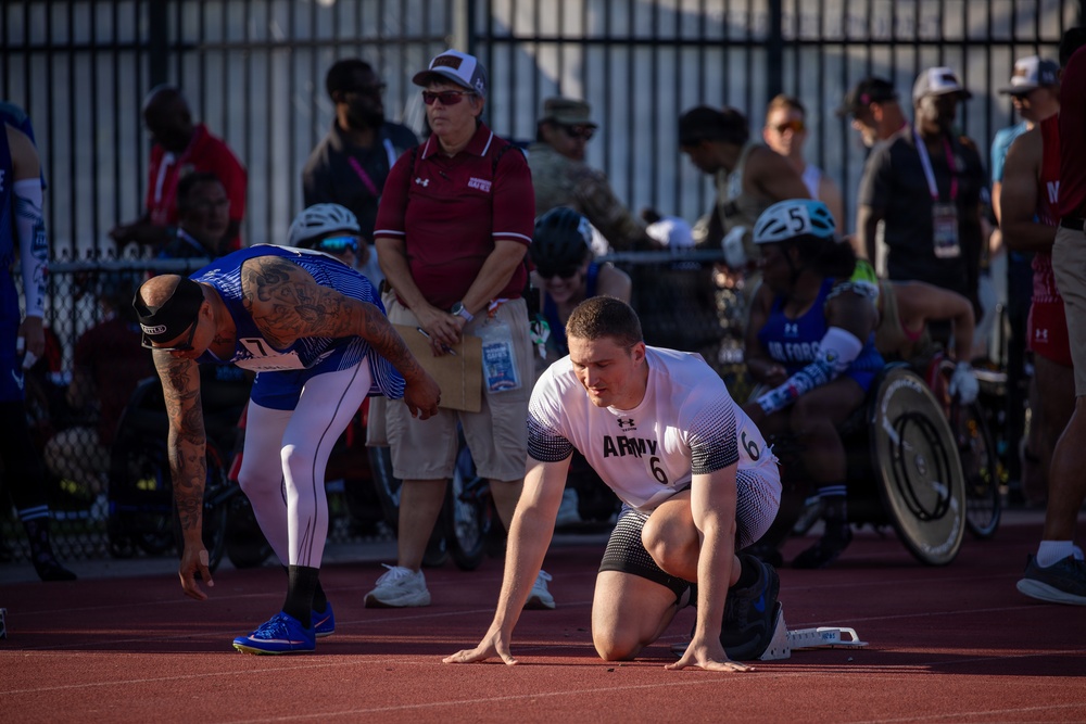 Army and Air Force Athletes Prepare at Starting Blocks During Track Competition