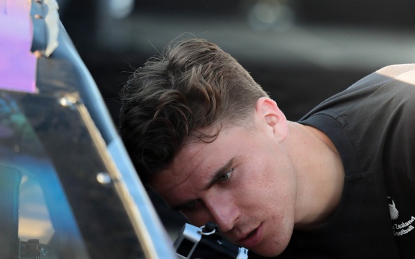 New Zealand National Football Team player takes photo of NASCAR race car