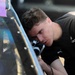 New Zealand National Football Team player takes photo of NASCAR race car