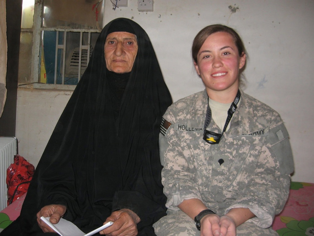 U.S. Army Spc. Selena Holleman with the 163rd Area Support Medical Company, during an examination for the civilian female population in Baqubah, Iraq, 2010.