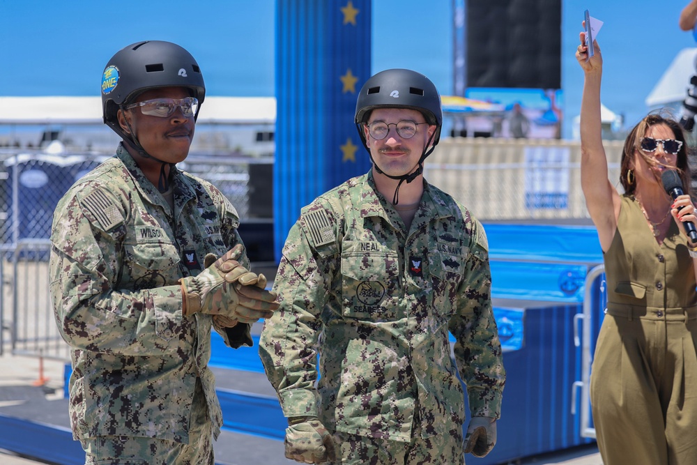 Sailors compete in the NASCAR Pit Crew Challenge