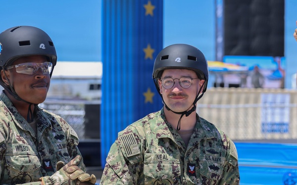 Sailors compete in the NASCAR Pit Crew Challenge