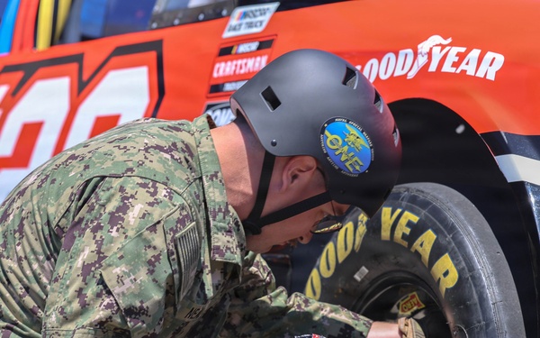 Sailors compete in the NASCAR Pit Crew Challenge