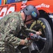 Sailors compete in the NASCAR Pit Crew Challenge