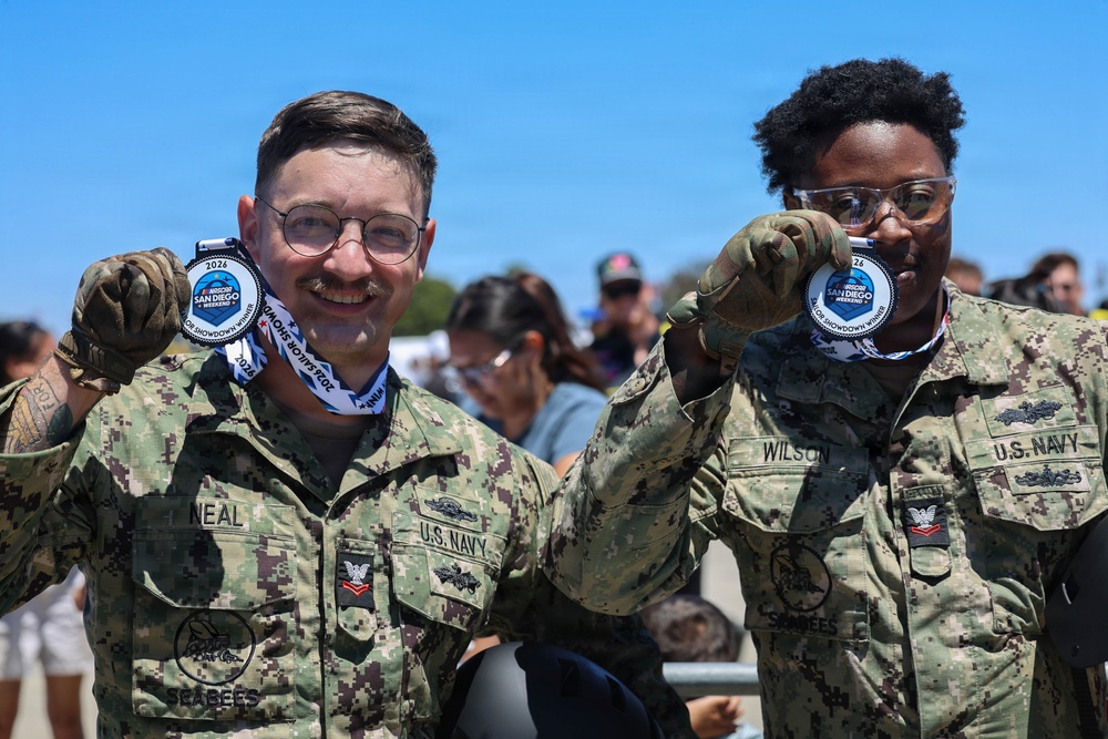 Sailors compete in the NASCAR Pit Crew Challenge