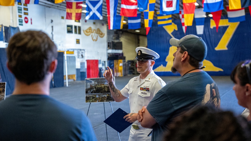 Sailor gives a tour aboard Wasp-class amphibious assault ship USS Iwo Jima (LHD 7)