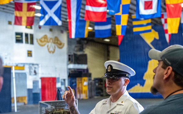 Sailor gives a tour aboard Wasp-class amphibious assault ship USS Iwo Jima (LHD 7)
