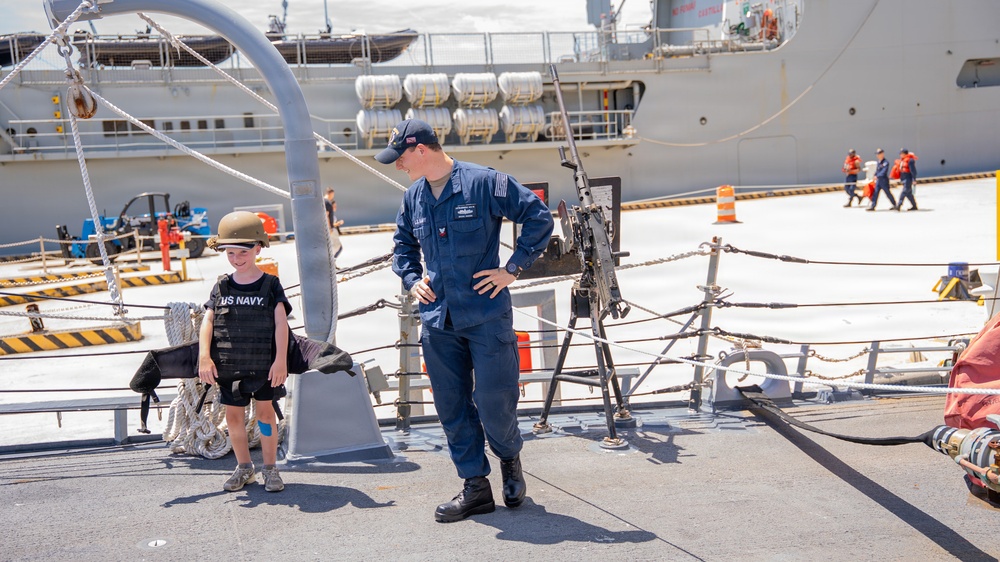 Sailor conducts a tour aboard Arleigh Burke-class guided-missile destroyer USS Bainbridge (DDG 96)