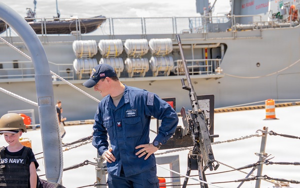 Sailor conducts a tour aboard Arleigh Burke-class guided-missile destroyer USS Bainbridge (DDG 96)