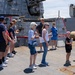 Sailor conducts a tour aboard Arleigh Burke-class guided-missile destroyer USS Bainbridge (DDG 96)
