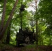 Soldiers operate military communications vehicle concealed in forest during Spectrum Blitz 26