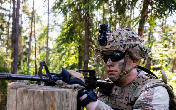 U.S. Army Soldier takes cover behind log obstacle during Spectrum Blitz 26