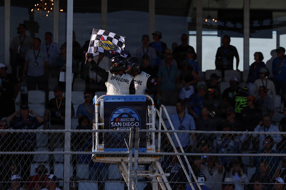 NASCAR official waves checkered flag to signify the end of the NASCAR Cup Series: Anduril 250 Race the Base at NASCAR San Diego Weekend
