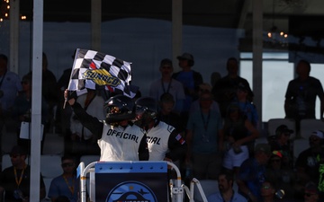 NASCAR official waves checkered flag to signify the end of the NASCAR Cup Series: Anduril 250 Race the Base at NASCAR San Diego Weekend