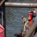 Curtin crew members perform equipment maintenance