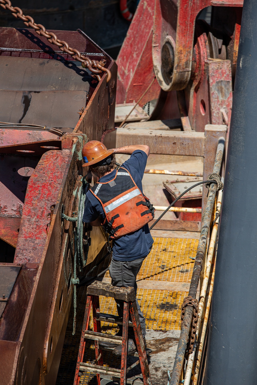 Curtin crew members perform equipment maintenance