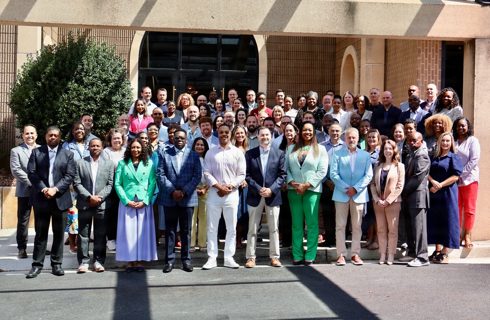 Large Group Poses for Formal Photo Outside Institutional Building