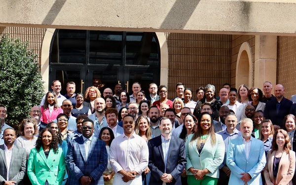 Large Group Poses for Formal Photo Outside Institutional Building