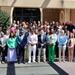 Large Group Poses for Formal Photo Outside Institutional Building