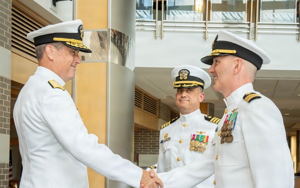 Rear Adm. Tony Rossi, left, shakes hands with incoming PMA-260 program manager Capt. James Bailey at PMA-260 change of command ceremony