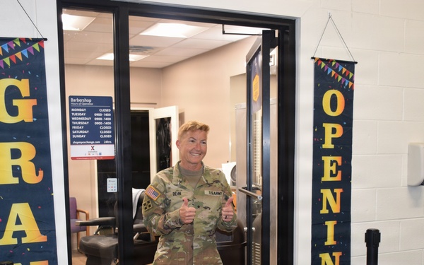 Brig. Gen. Beth Behn exits the barbershop after receiving the first haircut