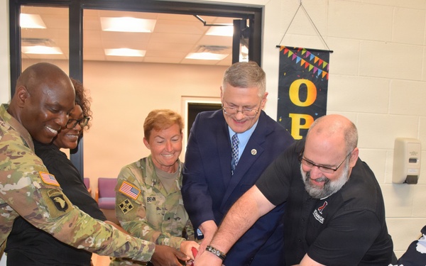 Cutting the ribbon at the Detroit Arsenal barbershop grand opening