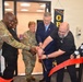 Cutting the ribbon at the Detroit Arsenal barbershop grand opening