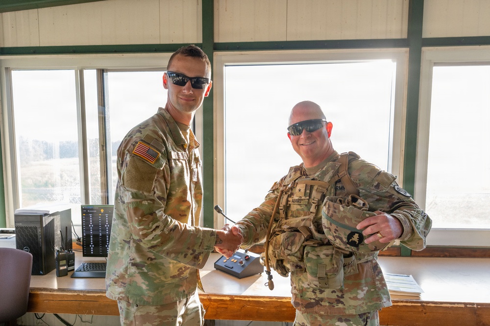 Iowa National Guard brigadier general presents challenge coin to 1034th CSSB soldier