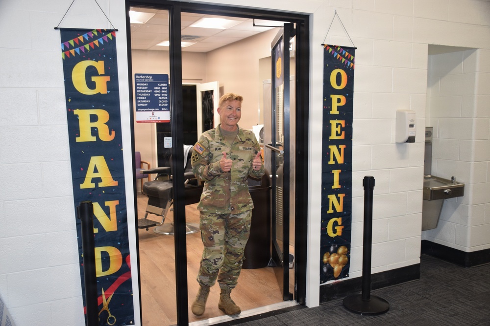 Brig. Gen. Beth Behn exits the barbershop after receiving the first haircut