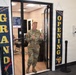 Brig. Gen. Beth Behn exits the barbershop after receiving the first haircut