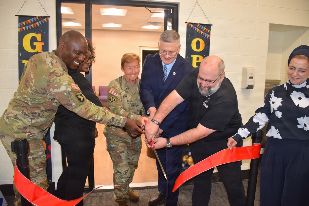 Cutting the ribbon at the Detroit Arsenal barbershop grand opening