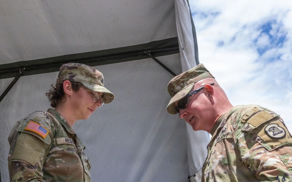 1034th CSSB Soldier receives challenge coin during annual training
