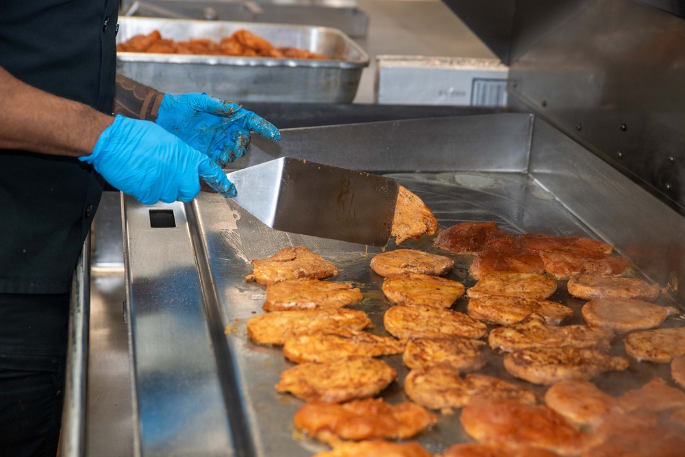 Ronald Reagan Sailors Prepare Food For Opening Of Ships Galley