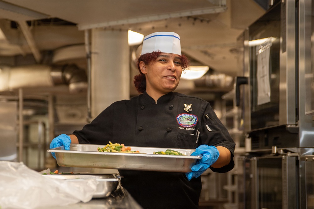 Ronald Reagan Sailors Prepare Food For Opening Of Ships Galley