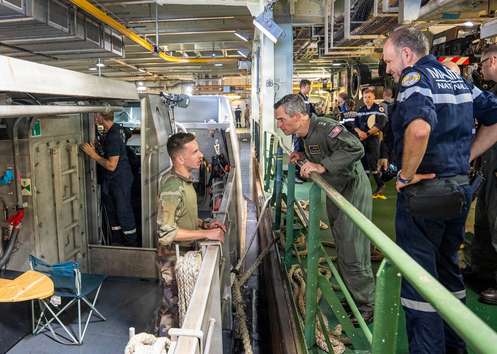 Vice Adm. Doug Perry, commander, U.S. 2nd Fleet, speaks to a French navy sailor