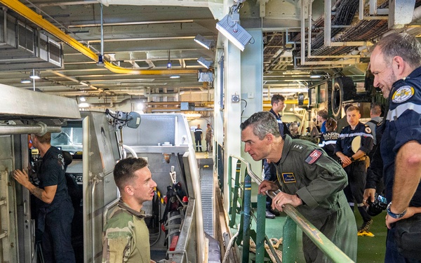 Vice Adm. Doug Perry, commander, U.S. 2nd Fleet, speaks to a French navy sailor
