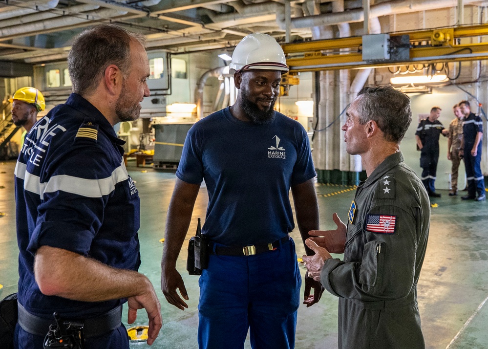 Vice Adm. Doug Perry, commander, U.S. 2nd Fleet, speaks to a French navy sailor
