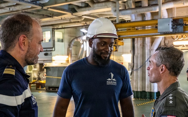 Vice Adm. Doug Perry, commander, U.S. 2nd Fleet, speaks to a French navy sailor
