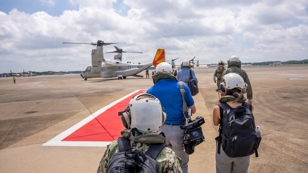 Vice Adm. Doug Perry, commander, U.S. 2nd Fleet, alongside members of the media, boards a CMV-22B Osprey