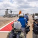 Vice Adm. Doug Perry, commander, U.S. 2nd Fleet, alongside members of the media, boards a CMV-22B Osprey