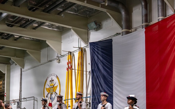 Vice Adm. Doug Perry, commander, U.S. 2nd Fleet, salutes French navy sailors alongside Capt. Jocelyn Delrieu