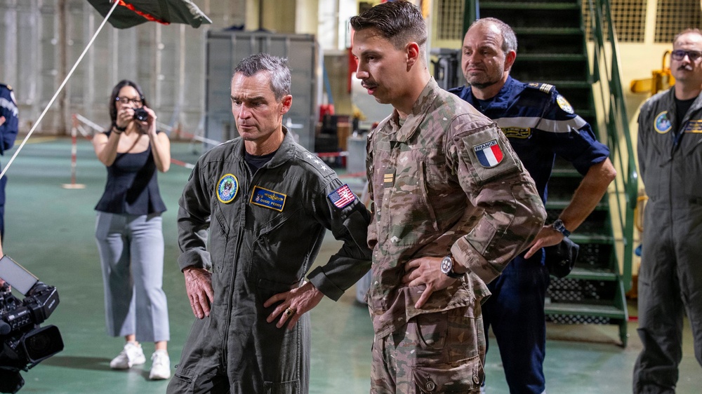 Vice Adm. Doug Perry, commander, U.S. 2nd Fleet, speaks to a French navy sailor