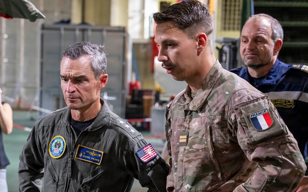 Vice Adm. Doug Perry, commander, U.S. 2nd Fleet, speaks to a French navy sailor