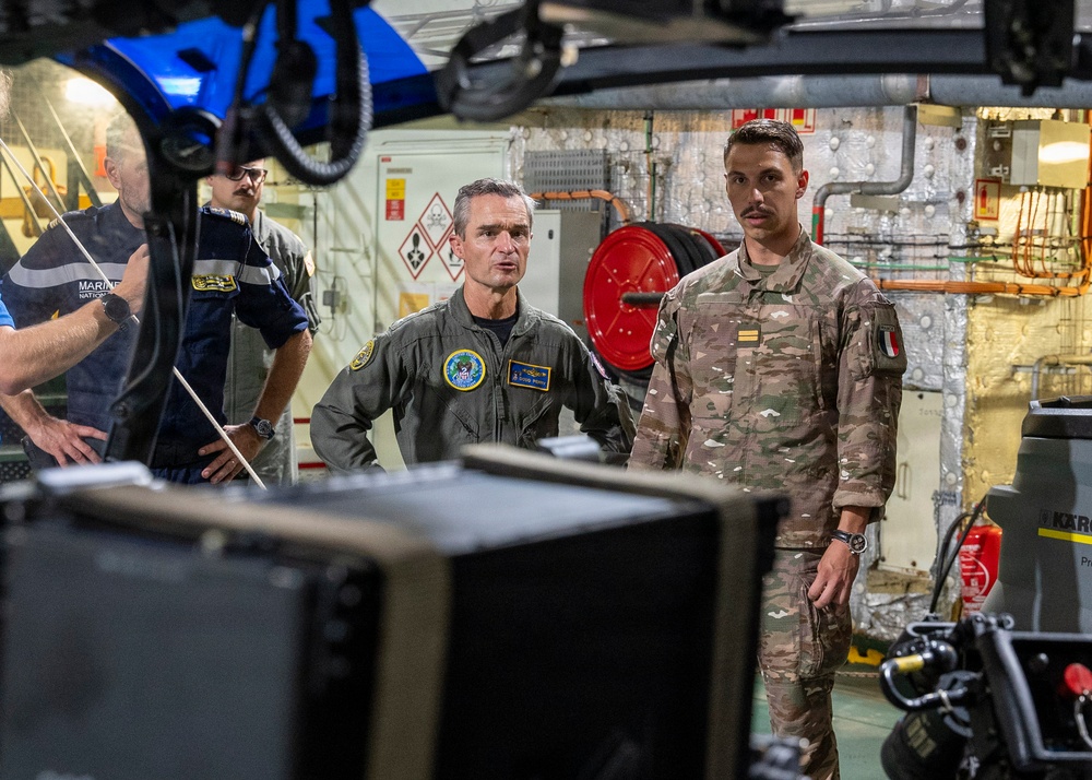 Vice Adm. Doug Perry, commander, U.S. 2nd Fleet, speaks to a French navy sailor