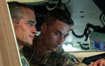 Vice Adm. Doug Perry, commander, U.S. 2nd Fleet, speaks to a French navy sailor