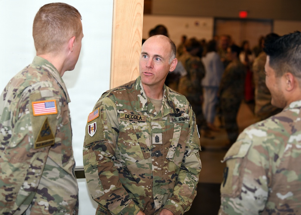 DeCola talks with attendees