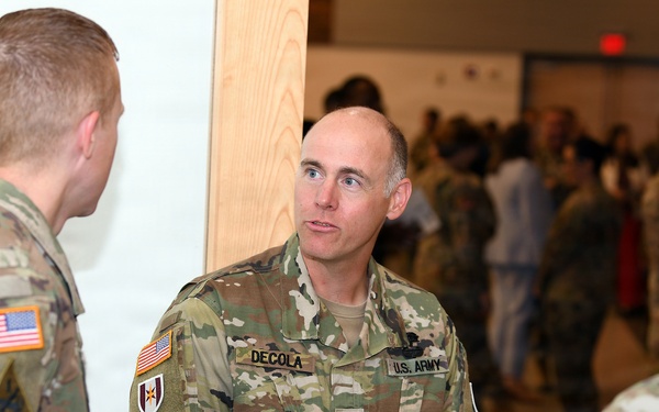 DeCola talks with attendees