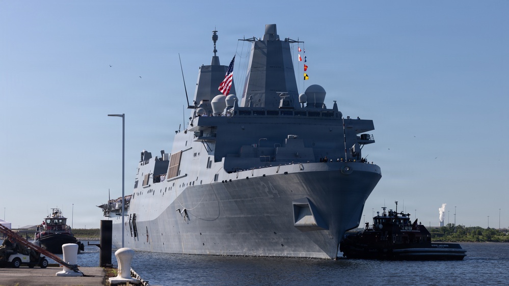 U.S. Marines and Sailors man the rails aboard the USS Arlington (LPD-24)