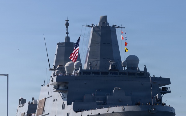 U.S. Marines and Sailors man the rails aboard the USS Arlington (LPD-24)